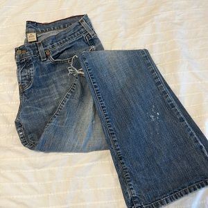 Abercrombie & Fitch low rise distressed bootcut jeans.